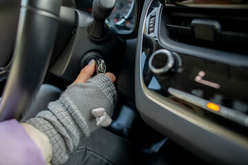 Starting a Car CloseUp on Ignition with a Gloved Hand, Ready for the Journey Ahead