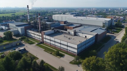 Industrial Facility Aerial View: Large buildings with smokestack emissions.