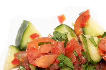 A chunky salsa salad of tomatoes and cucumber and herbs close up of salad vegetables