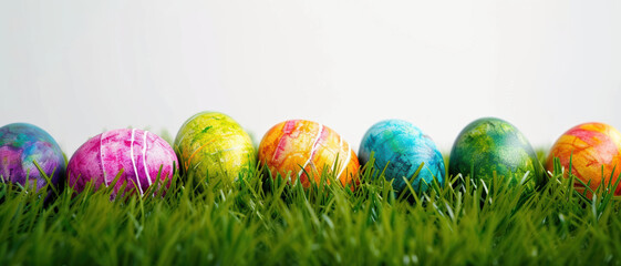 Fototapeta premium Vibrantly colored easter eggs nestled in fresh grass perfect for spring holiday celebrations and decor inspiration