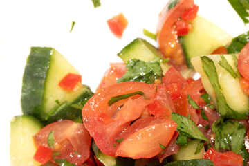 A chunky salsa salad of tomatoes and cucumber and herbs close up of salad vegetables
