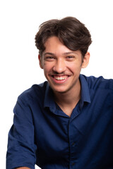 Young handsome student with black hair and blue shirt, sitting and smiling, looking at camera. Isolated on white background. Confident person.