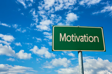 Motivation Signpost under Blue Sky: A bright green signpost displaying the word "Motivation," set against a vivid blue sky adorned with fluffy, white clouds.