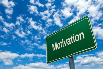 Motivation Sign Against Sky: A verdant green road sign proclaims 'Motivation' against a backdrop of a vibrant blue sky and scattered fluffy clouds, representing inspiration and encouragement.
