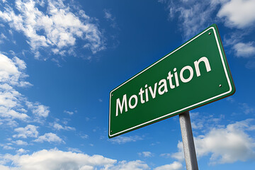 Motivation Road Sign Under Bright Blue Sky: A vibrant green road sign, prominently displaying the word "Motivation" in bold white letters.