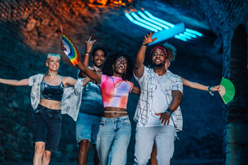 Friends dancing together at music festival, enjoying the show