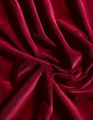 Obraz premium Luxurious red velvet fabric rests in gentle folds, highlighting its smooth texture and vibrant hue. This material is perfect for craft projects and decorative purposes. Generative AI