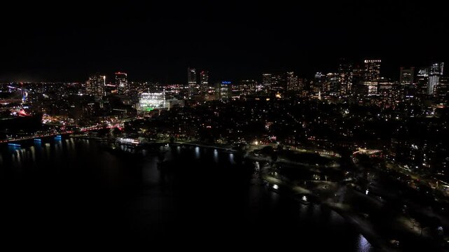 night aerial footage of the downtown city of Boston with buildings with lights