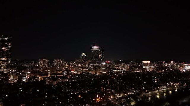 night aerial footage of the downtown city of Boston with buildings with lights
