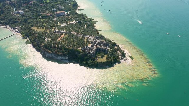 Grotto of Catullus Sirmione Lake of Garda Aerial Drone View. Archaeological site of Grotte di Catullo, Sirmione, Italy early morning aerial view. lake garda.