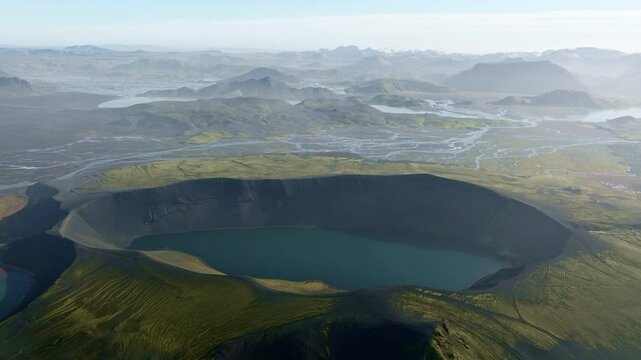 Lake Ljotipollur With Hazy Rolling Hills Stretching Into The Horizon