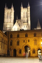 Lincoln Cathedral by night, with Exchequer Gate in the foreground.