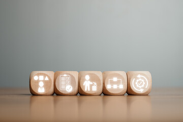 Wooden blocks depicting the 5S methodology icons for improving workplace organization and efficiency.