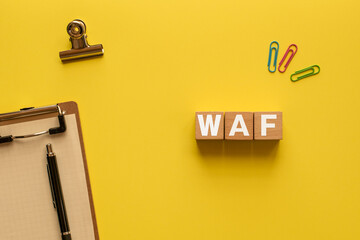 There is wood cube with the word WAF. It is an abbreviation for Web Application Firewall as eye-catching image.