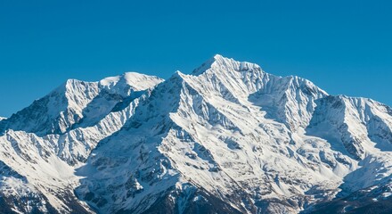 Majestic mountain range with snow-capped peaks and clear blue sky