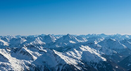 Majestic mountain range with snow-capped peaks and clear blue sky