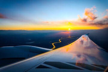 Scenery sunset view from the window of airplane. 