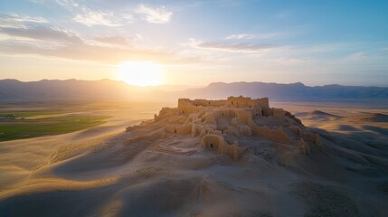 Obraz premium Ruined castle atop sandy hill against bright sunset. Travel destination background for historic tourism sites