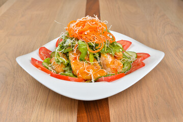 Elegant shrimp salad with tomatoes cucumbers and shredded carrots a delightful culinary creation
