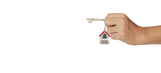 Hand holding key with house charm real estate digital image studio background close-up homeownership concept
