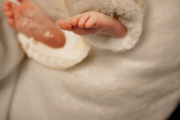 Tender Close-Up of a Baby's Feet in a Soft White Outfit
