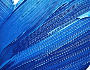 Fototapeta premium close up shot of a vibrant blue paint texture, with brush strokes creating a dynamic pattern