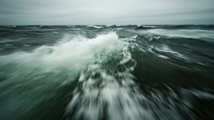 Obraz premium Stormy sea waves, boat wake, ocean, grey sky, travel