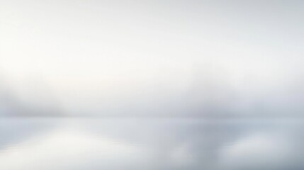 Obraz premium Soft Mist Over Calm Water Surface with Gentle Reflection in Serene Natural Landscape at Dawn