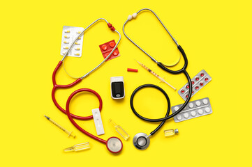 Composition with pulse oximeter, stethoscope and medicines on yellow background
