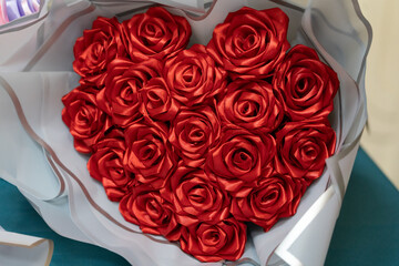 Heart-shaped bouquet of red roses presented on a table