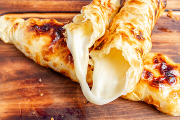 Crispy cheese-filled pastries on a wooden table ready to enjoy