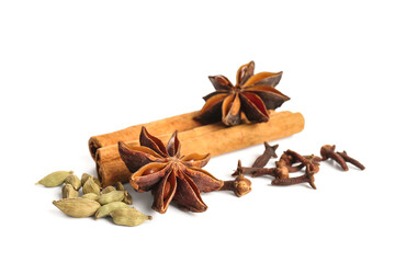 Anise stars with seeds, cloves and cinnamon on white background