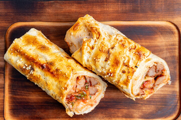 Freshly baked rolls with savory filling on a wooden board
