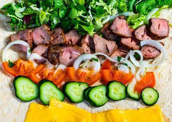 Savory wrap filled with grilled meat, fresh vegetables, and cheese