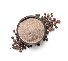 Bowl with black pepper powder and peppercorns on white background