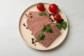 Pieces of tasty canned meat, parsley, peppercorns and tomatoes on white marble table, top view