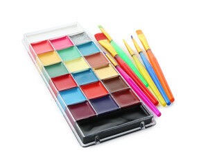 Naklejka premium Bright face paint palette and brushes isolated on white