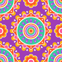 Fototapeta premium Seamless pattern. Colorful symmetrical mandala on a purple background. Holi festival of colors. Indian mandala. Fabric, wrapping paper.