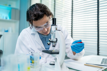 Asian male scientist working in the biotechnology research laboratory.