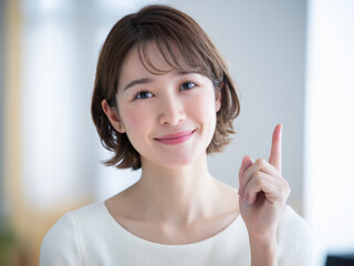 指差す若い日本人女性（ポイント・要点）　Generative AI	
