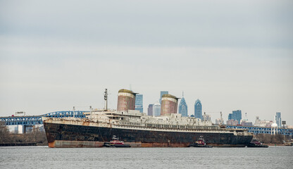 The SS United States Liner on it's way to Destin Florida where it will become an artificial reef sales past the Philadelphia Skyline where it's been docked since 1996

