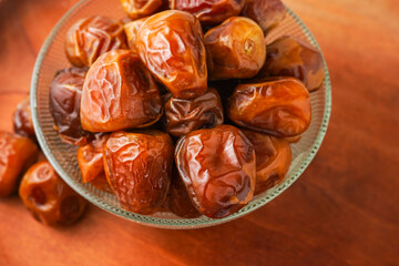 Dates fruit sukari or kurma sukari, in bowl isolated on white background