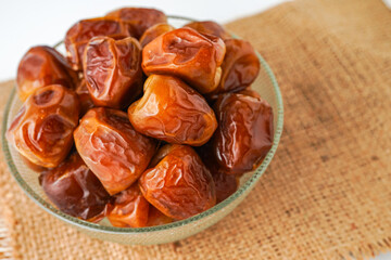 Dates fruit sukari or kurma sukari, in bowl isolated on white background