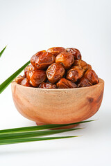Dates fruit sukari or kurma sukari, in wooden bowl isolated on white background