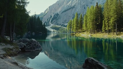 Video generation of a mountain lake with clear blue water and surrounding pine trees. Featuring peace and nature