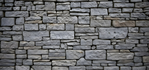 Fototapeta premium Graue Steinmauer mit vielen unterschiedlichen Ziegeln