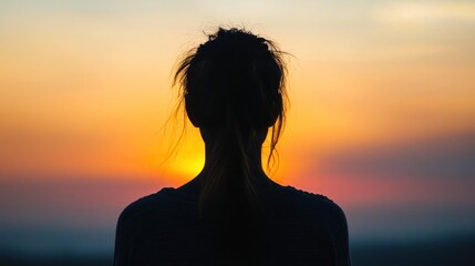 Fototapeta premium Silhouette of a Woman Watching Sunset