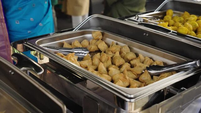 Little Samosas In Catering Tray On Banquet Table. Hindu Wedding Reception. closeup shot