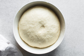 Overhead view of proofed challah bread dough, process of making challah
