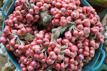 Onion bunch in the basket after harvest tied to easy for store and sale. Top view.